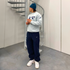 Model wears Nike Trackpants and Vintage Clohtes in Y2K Streetwear Optic.