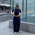 Model wears Nike Trackpants and Vintage Clohtes in Y2K Streetwear Optic.