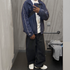 Model wears Nike Trackpants and Vintage Clohtes in Y2K Streetwear Optic.